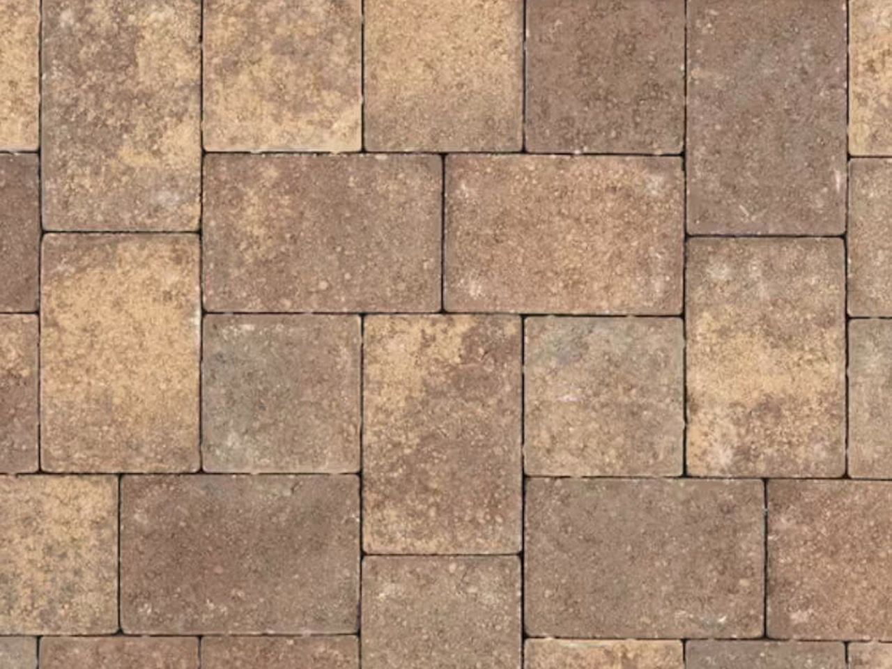 Earth-toned tumbled brick paver driveway in a modular pattern