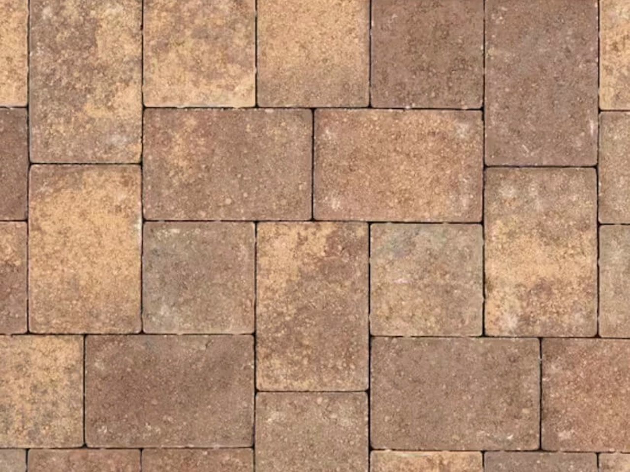 Earth-toned concrete pool deck pavers in a tumbled modular pattern