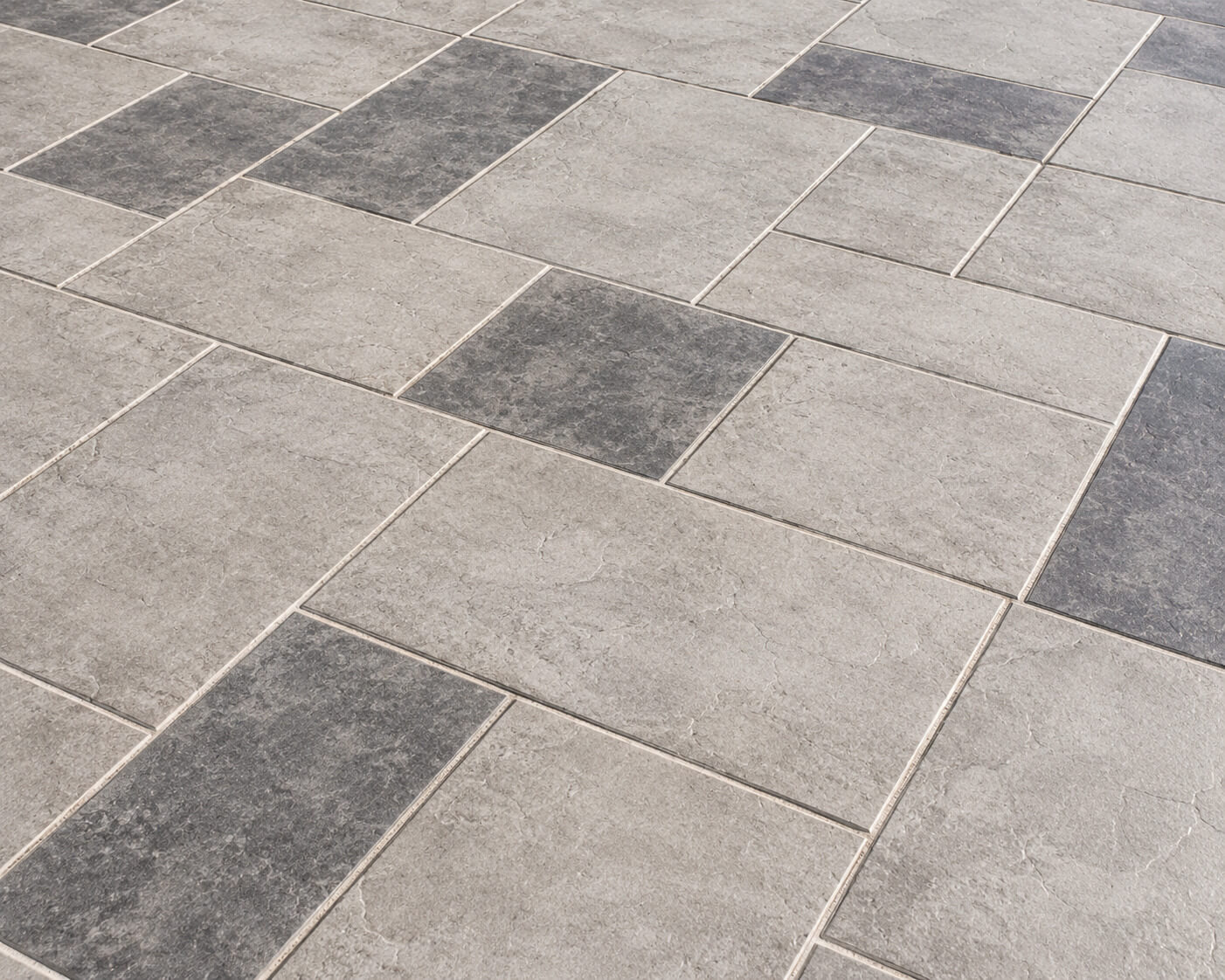 Gray modular tile pool deck overlay in a grid pattern