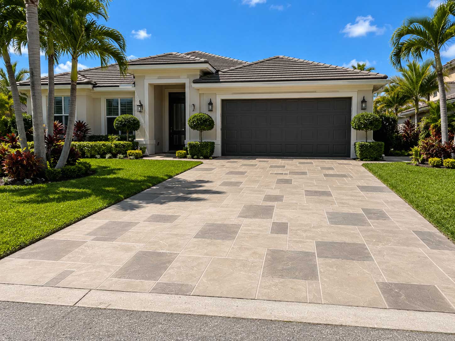 Rectangular stone paver driveway with a mixed beige and gray pattern