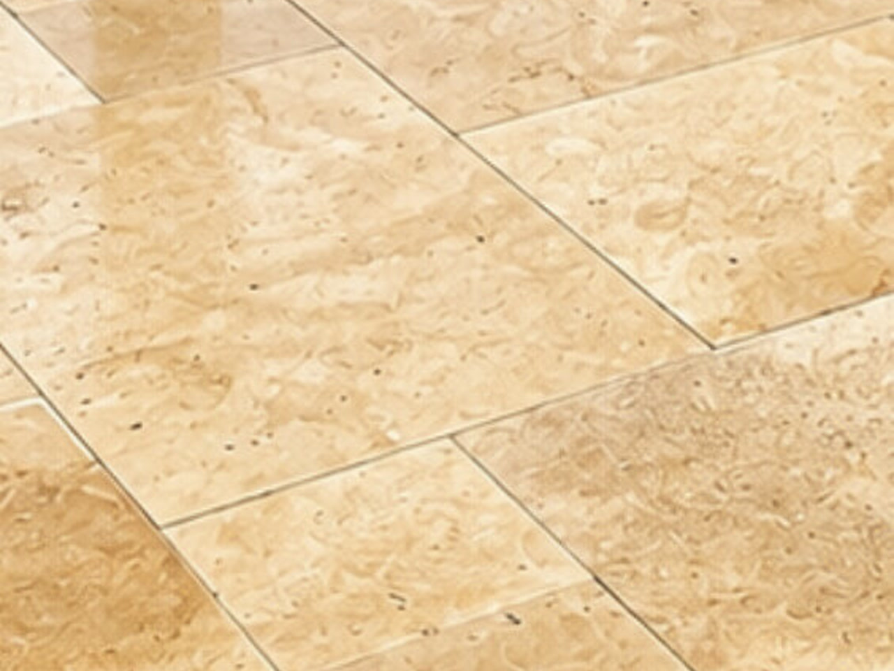 Ivory travertine paver driveway with a polished, variegated finish