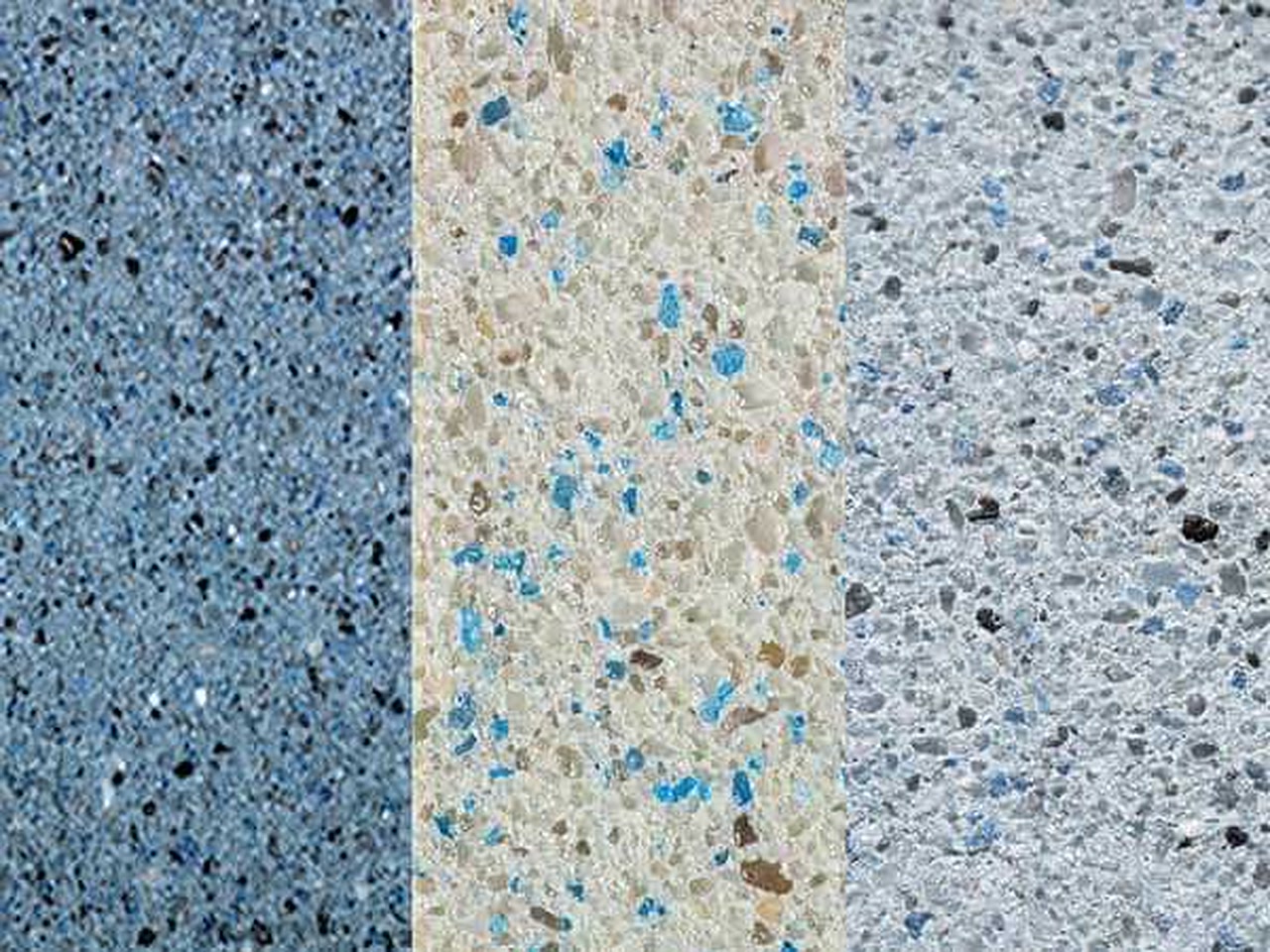 Three gem aggregate pool finish samples side by side, from steel blue to cream and pale gray with blue glass flecks